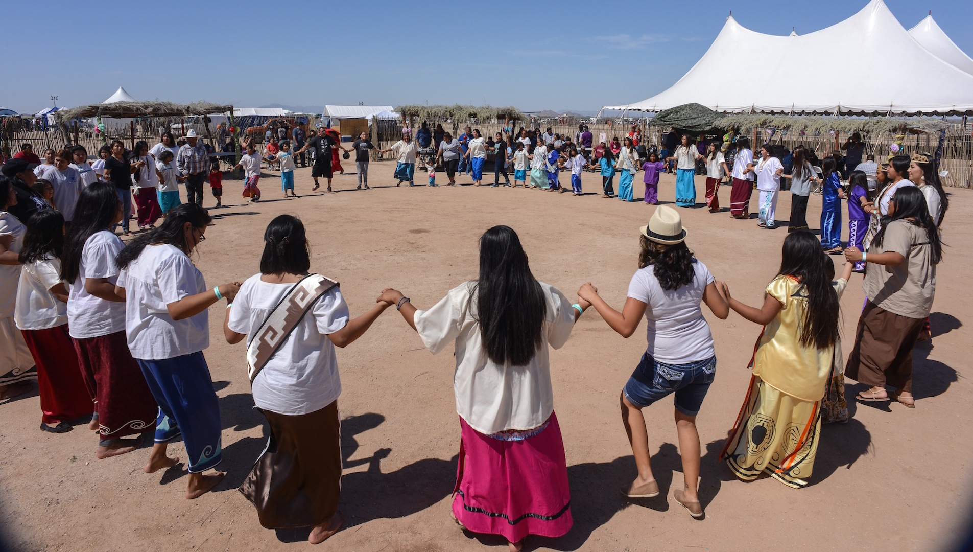 Dozens hold hands in a circle dance at a powwow on the Tohono O’Odham reservation.