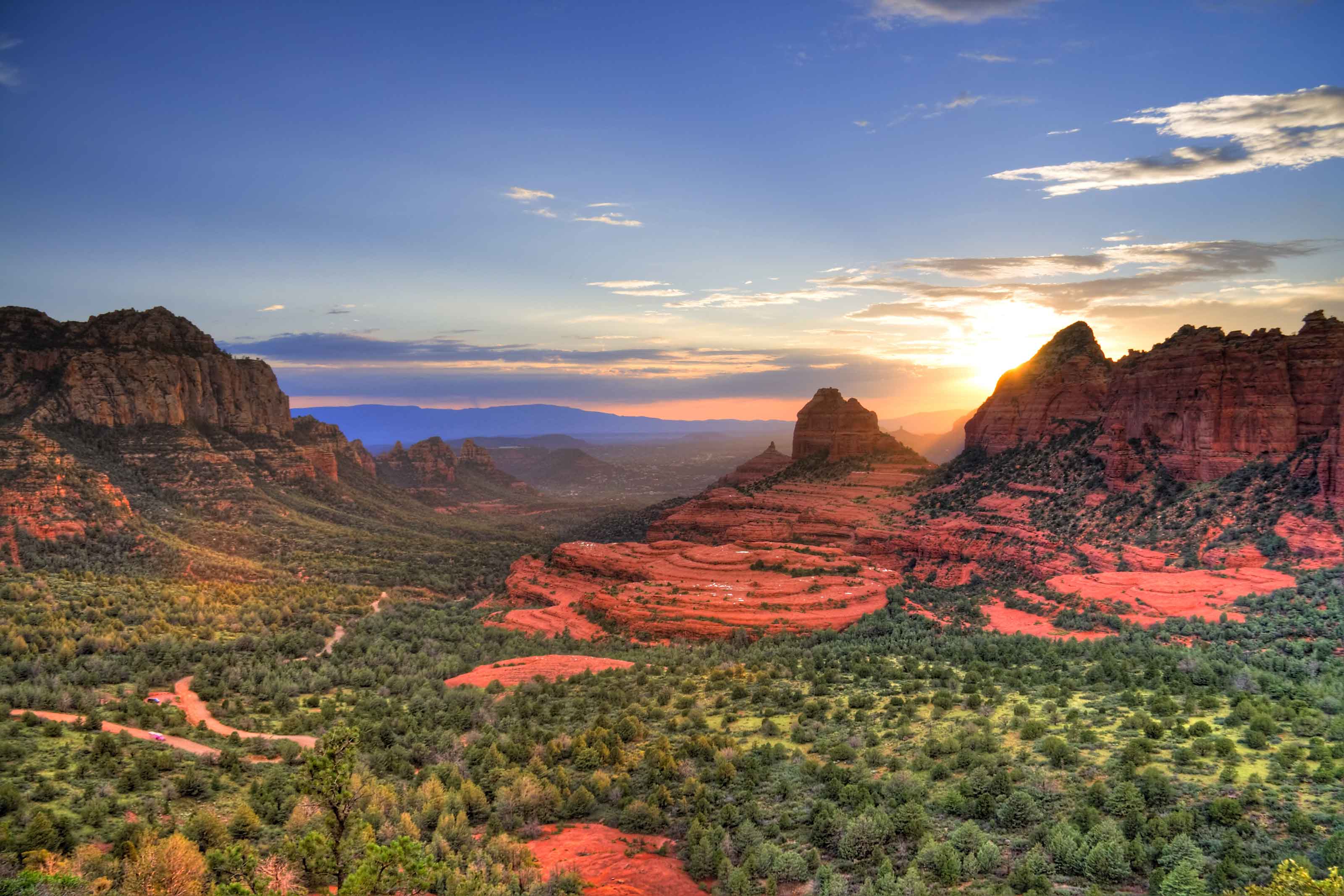 The last rays of sunlight illuminate the red rocks as seen from Merry-Go-Round Rock on Schnebly Hill Road east of Sedona, Arizona.